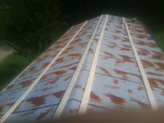 Rusted metal roof panels with new wood purlins before replacement — Storm Damage Roof Repair in Barnett by Roofing Brothers
