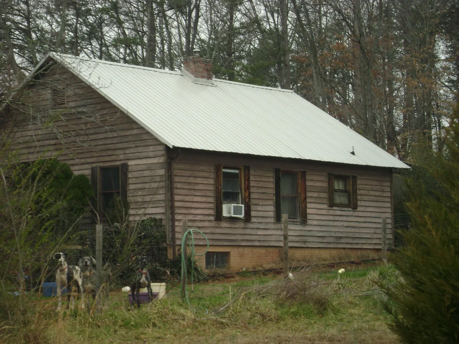 White metal roof on an old wood sided farmhouse, from a Asphalt Shingle Roof Repair job in Barnett